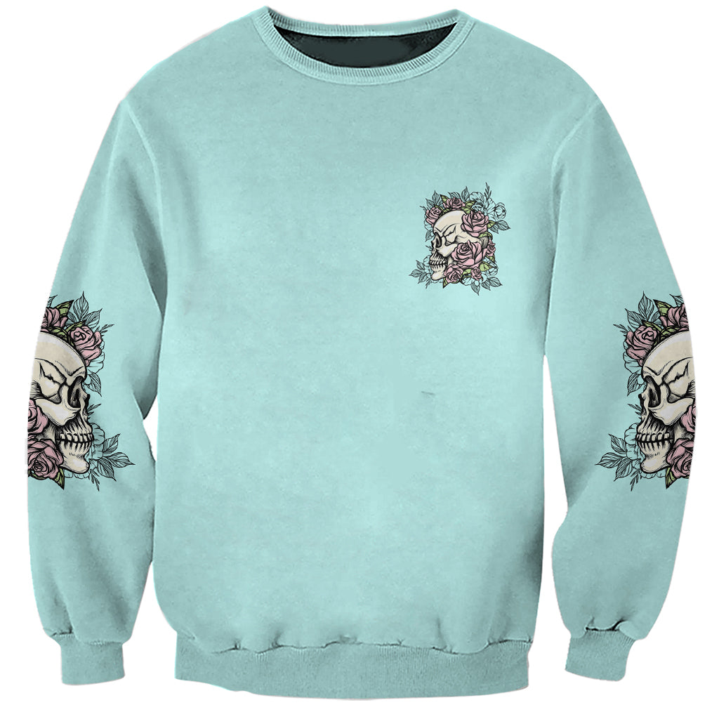 Unisex mint sweatshirt with small rose-and-skull emblem and rose prints on sleeves