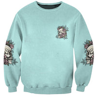 Unisex mint sweatshirt with small rose-and-skull emblem and rose prints on sleeves