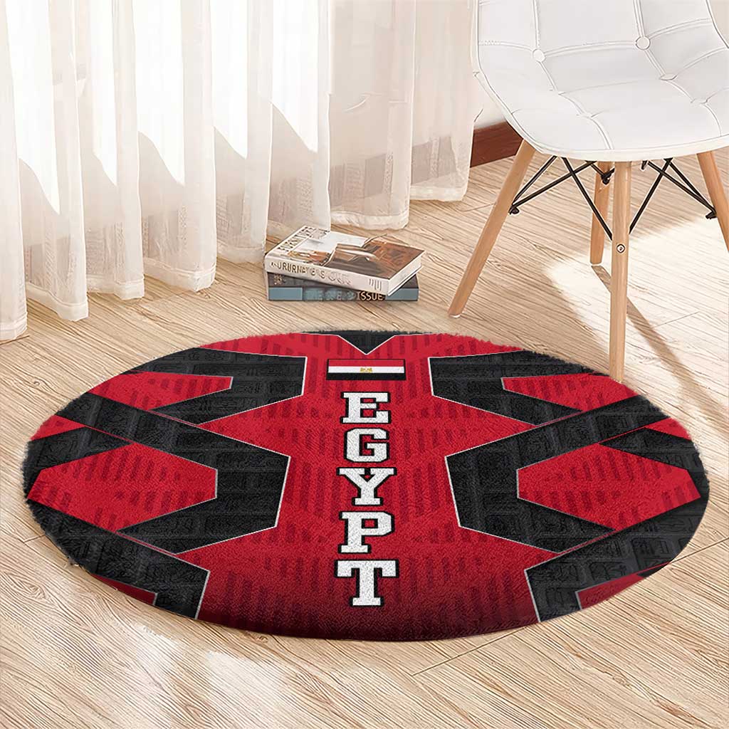 Round red and black EGYPT letter carpet on light wood floor