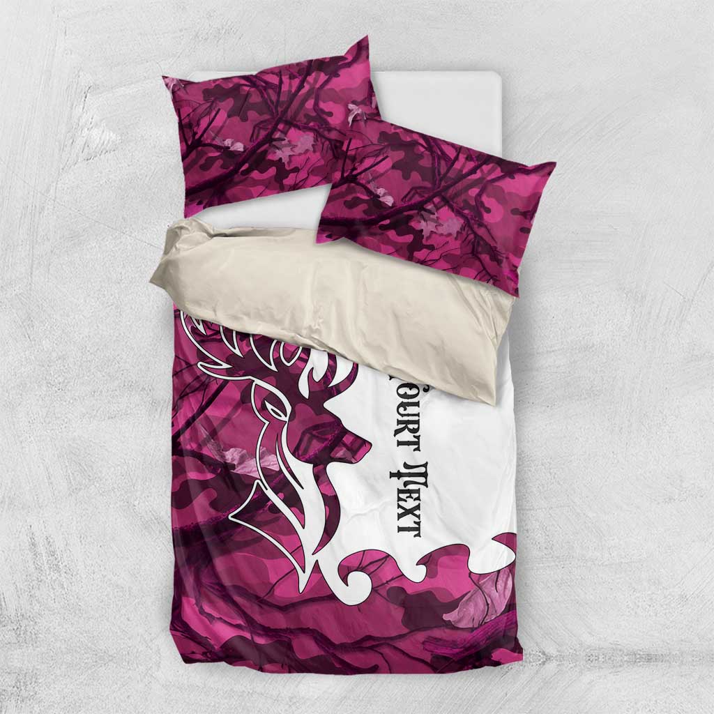 Pink camouflage bedding set laid flat: deer antler design, white panel, pillowcases included