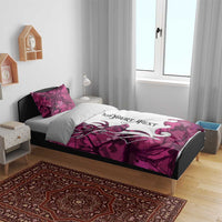Pink camo deer bedding set on bed with white duvet panel, antlers graphic, matching pillows