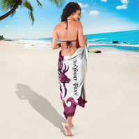 Pink camouflage sarong with buck silhouette and vertical tribal lettering, tied at neck, back view