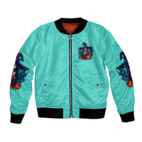 Unisex turquoise bomber jacket with front zipper, black cuffs, and small witch graphic