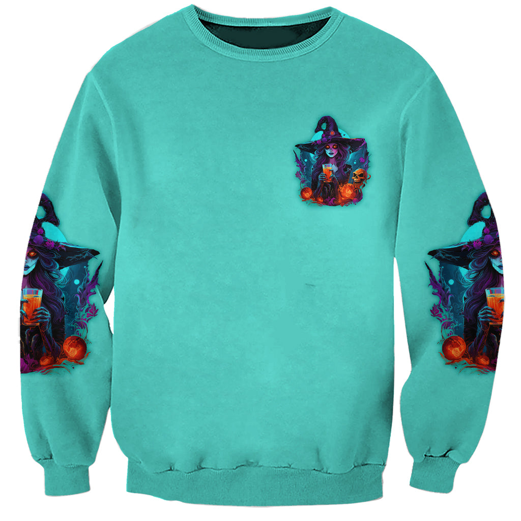 Unisex teal Halloween sweatshirt with small witch logo, sleeve skull accents