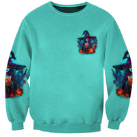 Unisex teal Halloween sweatshirt with small witch logo, sleeve skull accents