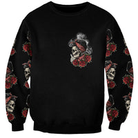 Unisex black crewneck sweatshirt with small skull-and-roses chest print and sleeve pattern