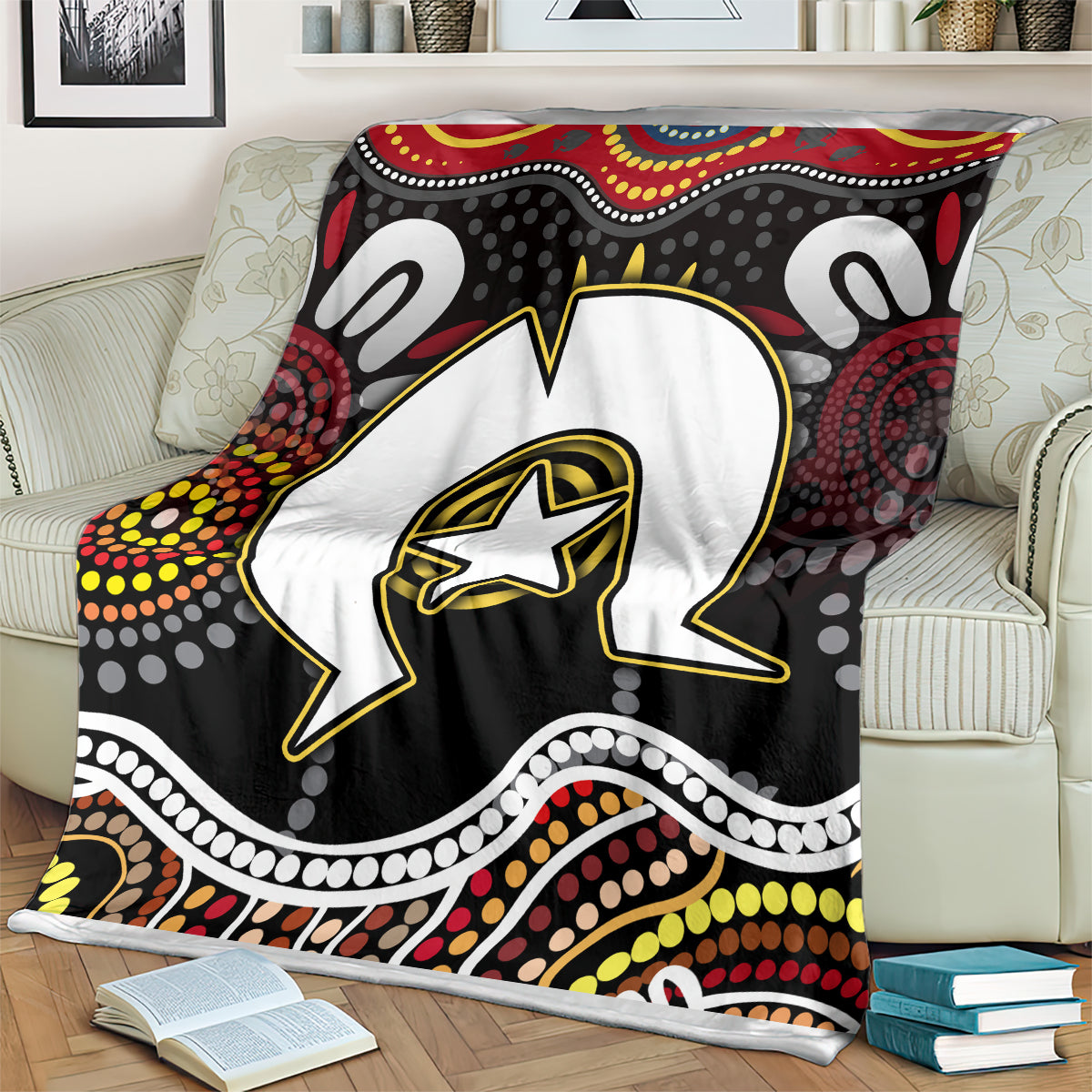 Multicolor Aboriginal pattern blanket on cream chair, bold star-outlined animal design
