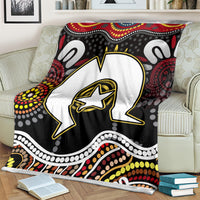 Multicolor Aboriginal pattern blanket on cream chair, bold star-outlined animal design