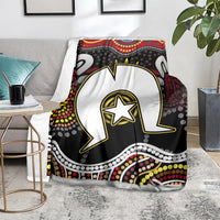Multicolor Aboriginal pattern blanket on gray armchair with white figure and star emblem