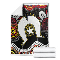 Folded multicolor Aboriginal pattern blanket with white, black, red, and yellow star graphic