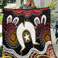 Black Aboriginal pattern quilt with large white emblem and multicolor dot accents