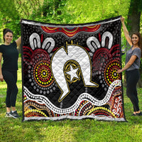 Multicolor Aboriginal pattern quilt with central white emblem and black dotted medallions