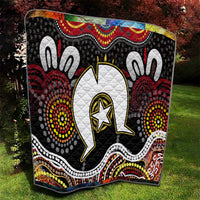 Black Aboriginal pattern quilt blanket with white central emblem and colorful border waves