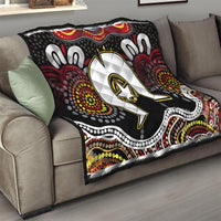 Black Aboriginal pattern throw quilt on a sofa with white star emblem and red dot details