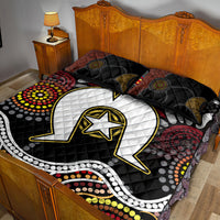 Black quilt with white lightning arch and gold star; two patterned decorative pillows