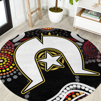 Round Aboriginal pattern rug with black and white lightning bolt and yellow star center.