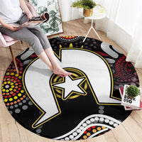 Round Aboriginal pattern rug, black lightning bolt design with yellow star and colorful dot border.