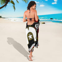 Aboriginal pattern sarong draped over shoulders, black with white curving lines and star