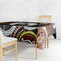 Multicolor aboriginal pattern tablecloth draped over rectangular table with black base