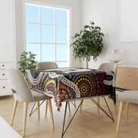 Multicolor aboriginal pattern tablecloth on dining table with black base and graphic motifs