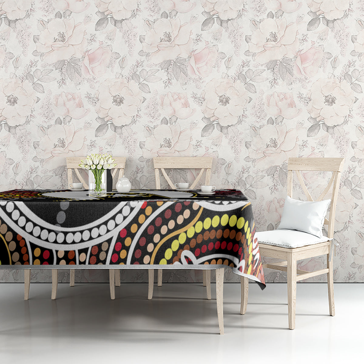 Multicolor aboriginal pattern tablecloth on table with floral wall backdrop; black base design