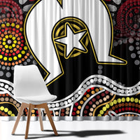 Close-up of black window curtain with large white/black figure outline and yellow accents.