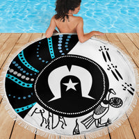 Round beach blanket with fringe and Aboriginal-style black, white, and turquoise pattern