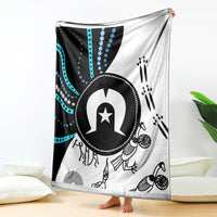 Aboriginal style throw blanket, black and white with blue dot and stripe pattern and central symbol