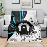 Black, white and blue Aboriginal pattern throw blanket draped on a couch