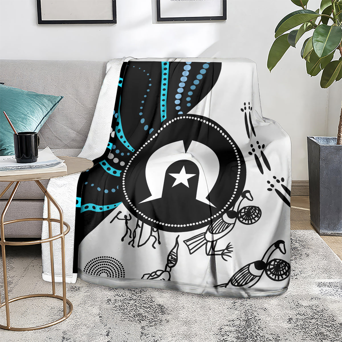 Black and white Aboriginal pattern throw blanket with blue accents laid on a chair