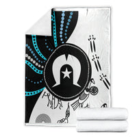 Folded Aboriginal style throw blanket set with black, white and blue central emblem and dots
