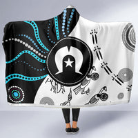 Draped hooded blanket towel with black, white, and teal Aboriginal-style circular patterns