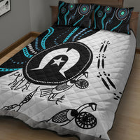 Multicolor Aboriginal pattern quilt bed set on bed: black, white, turquoise circular emblem and prints