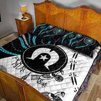 Multicolor Aboriginal pattern quilt bed set with black-and-white quilt and turquoise accents; two pillows