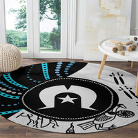 Round aboriginal-style rug with central star medallion and paw-print details, black and teal