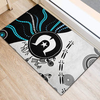 Rubber doormat with black, white, and blue dots, waves, and central circular emblem