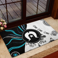 Black, white, and blue Aboriginal patterned rubber doormat with central circular emblem