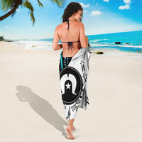 White and black sarong with turquoise accents and star emblem, tied wrap