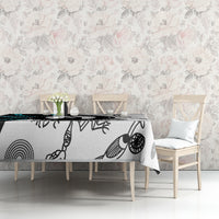 Aboriginal pattern tablecloth on long table with black, white, and teal abstract prints