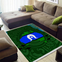 Green patterned area rug with blue and white emblem in center, tribal-style motifs