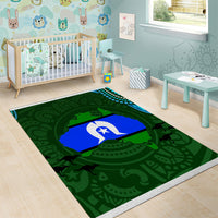 Green patterned area rug with blue center banner and white star icon, thin border