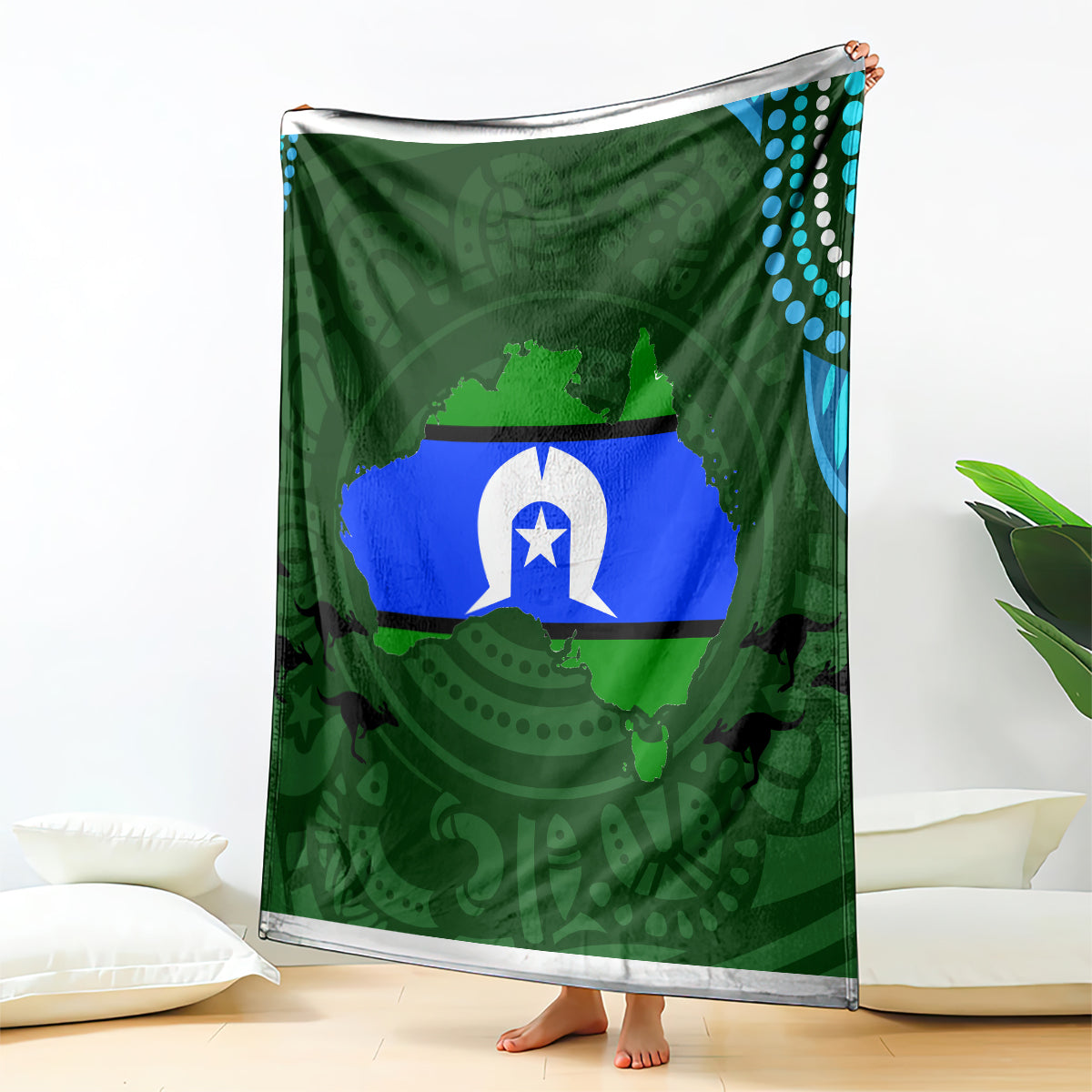 Green throw blanket with central flag graphic, teal dotted edge, draped upright