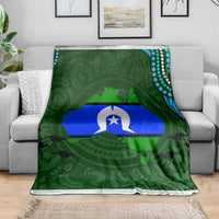 Green throw blanket with central flag graphic, Aboriginal pattern, white trim edge