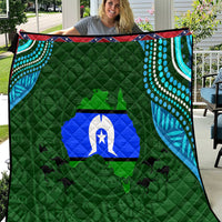 Green Aboriginal-style quilt with blue island emblem, teal swirl panels, and red trim