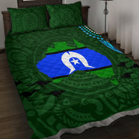 Green quilt bed set with blue-and-white flag quilt center; two dark-green swirl pillows