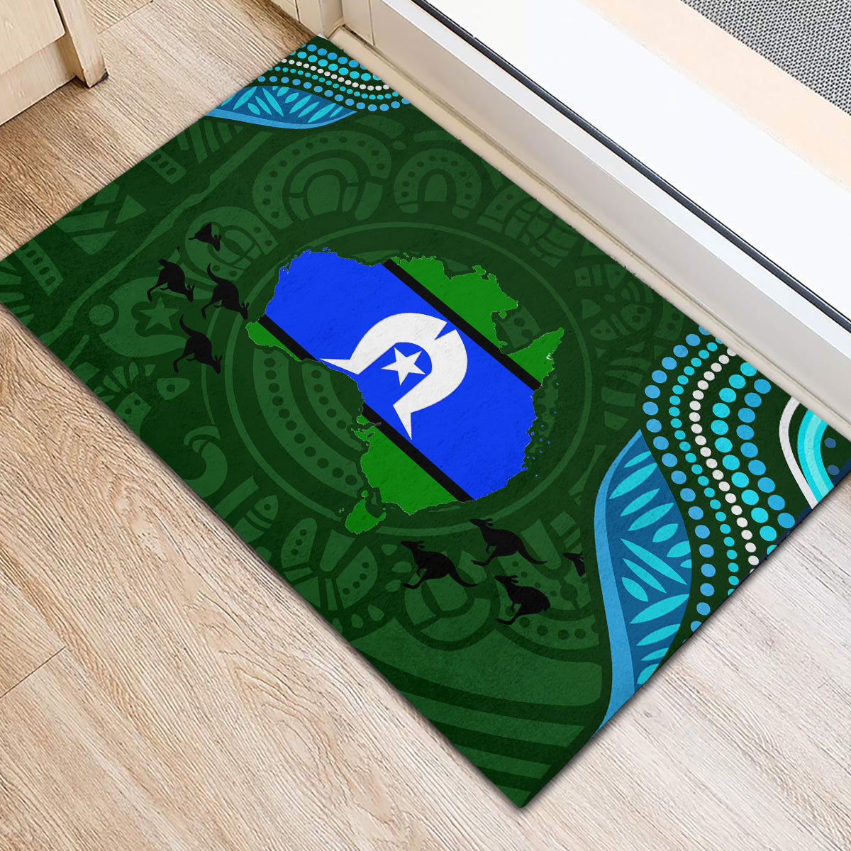 Green rubber doormat with Aboriginal-inspired dot and leaf borders, blue star center motif