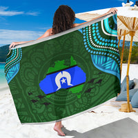 Green patterned sarong with circular island graphic and blue/white accents