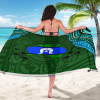 Green patterned sarong with circular emblem, blue dots, and white star motif