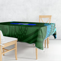 Green Aboriginal pattern tablecloth draped over dining table edge with blue accents