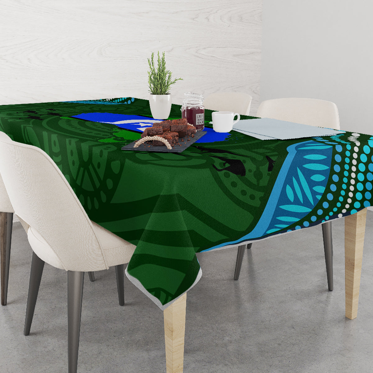 Green Aboriginal pattern tablecloth with teal/blue border and dark animal silhouettes